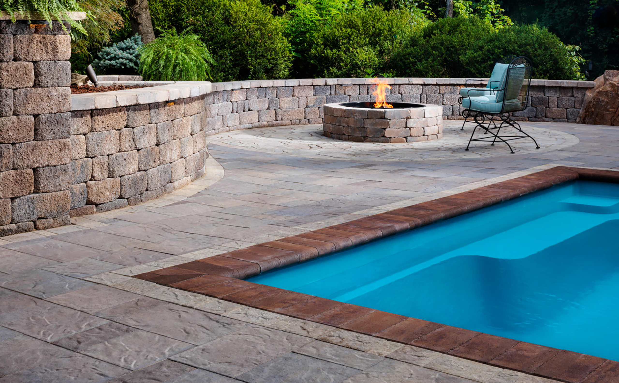 Luxurious backyard swimming pool designed by AR Stoneworks & Outdoor Living