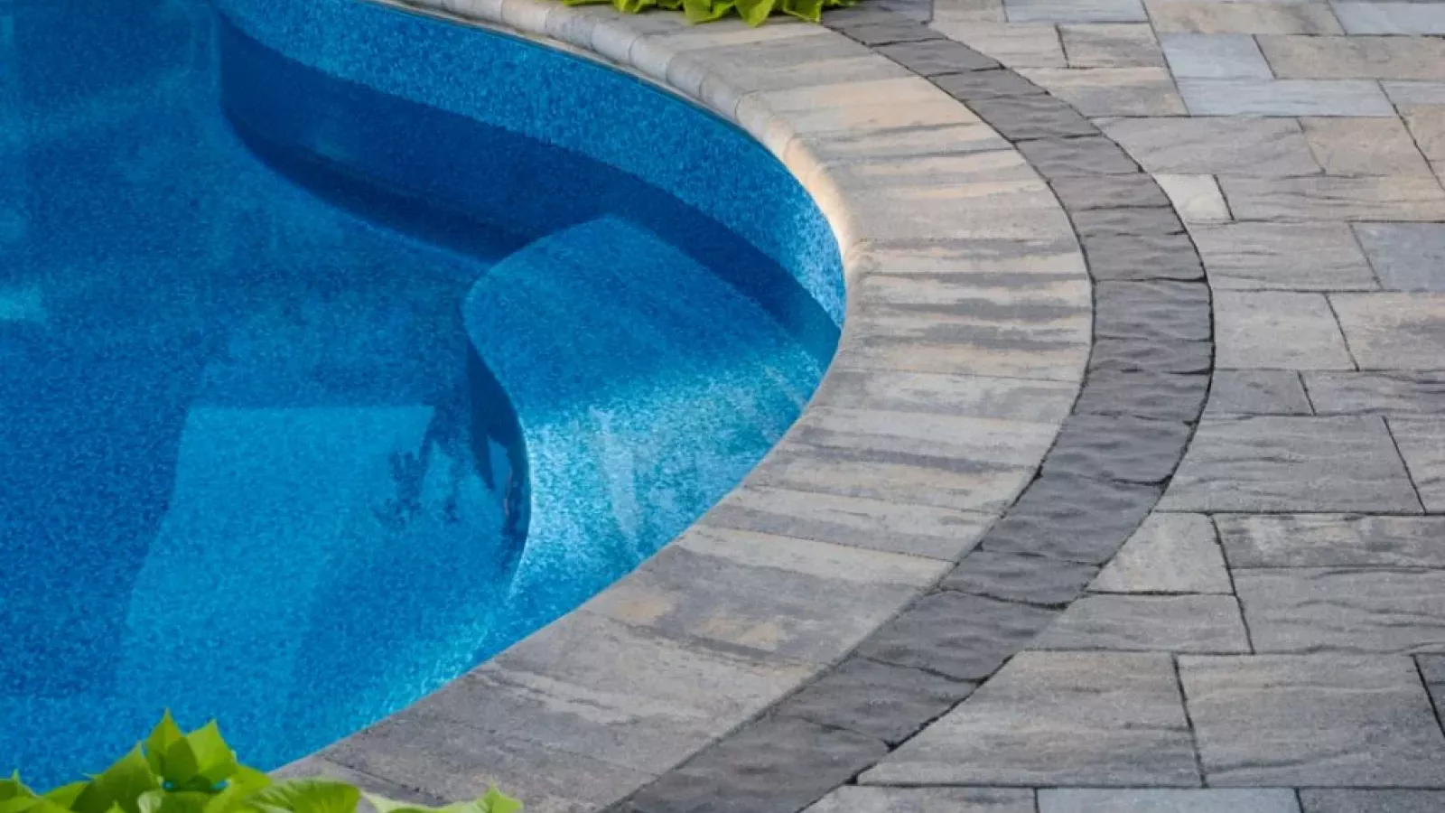 Smooth surface Marina™ Coping by Belgard, ideal for pools and outdoor steps.