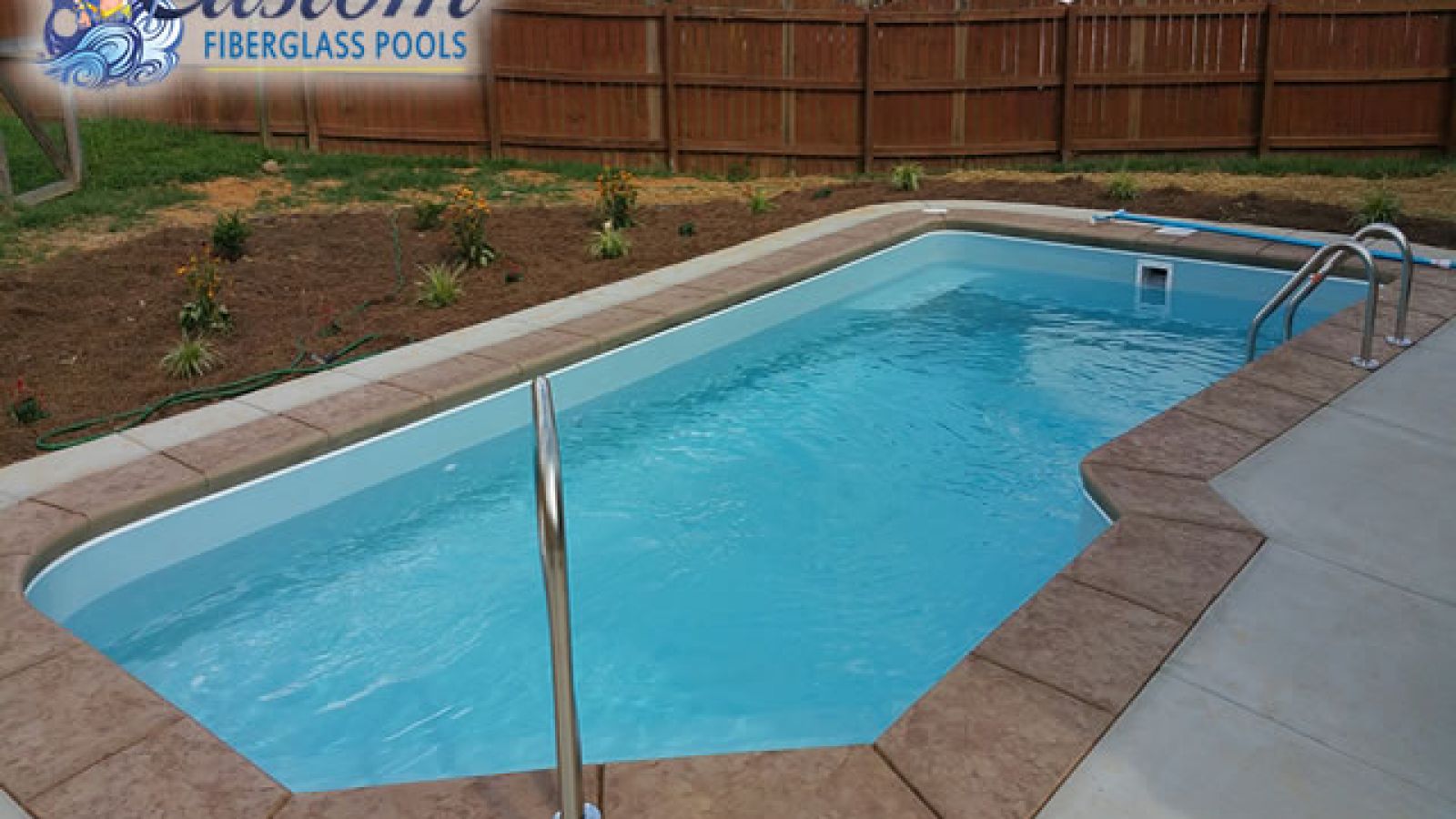 Mediterranean Custom Fiberglass Pool, a sleek and modern addition to a Clarksville, TN backyard