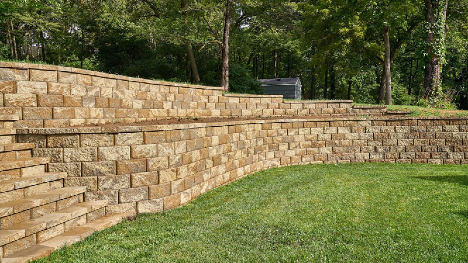 Regal Stone® Retaining Wall blocks by Keystone Hardscapes, symbolizing artistry, displayed at AR Stoneworks & Outdoor Living.
