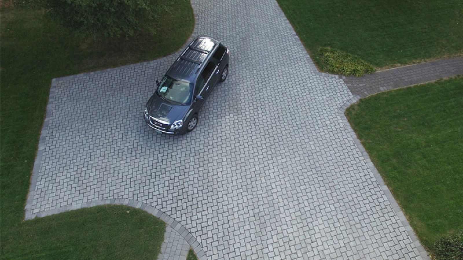 Enviro-Flo™ Permeable Pavers laid in a herringbone pattern by AR Pools • Stoneworks & Outdoor Living.